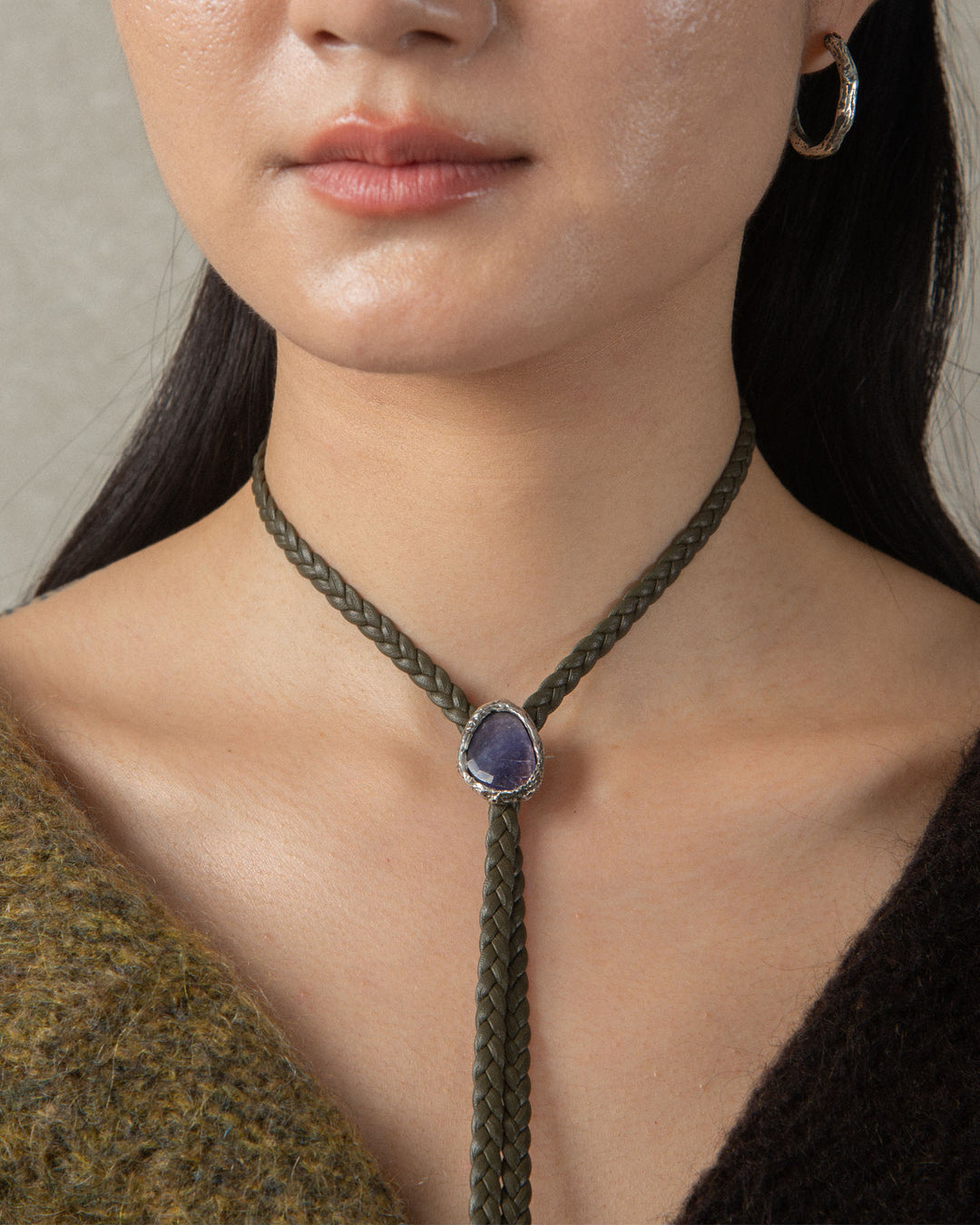 One-of-a-kind silver bolo tie with a textured frame encasing a luminous Kunzite stone, serving as a striking centerpiece