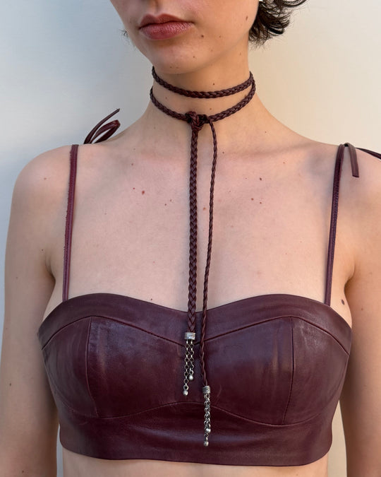 Brown leather top with a braided necklace