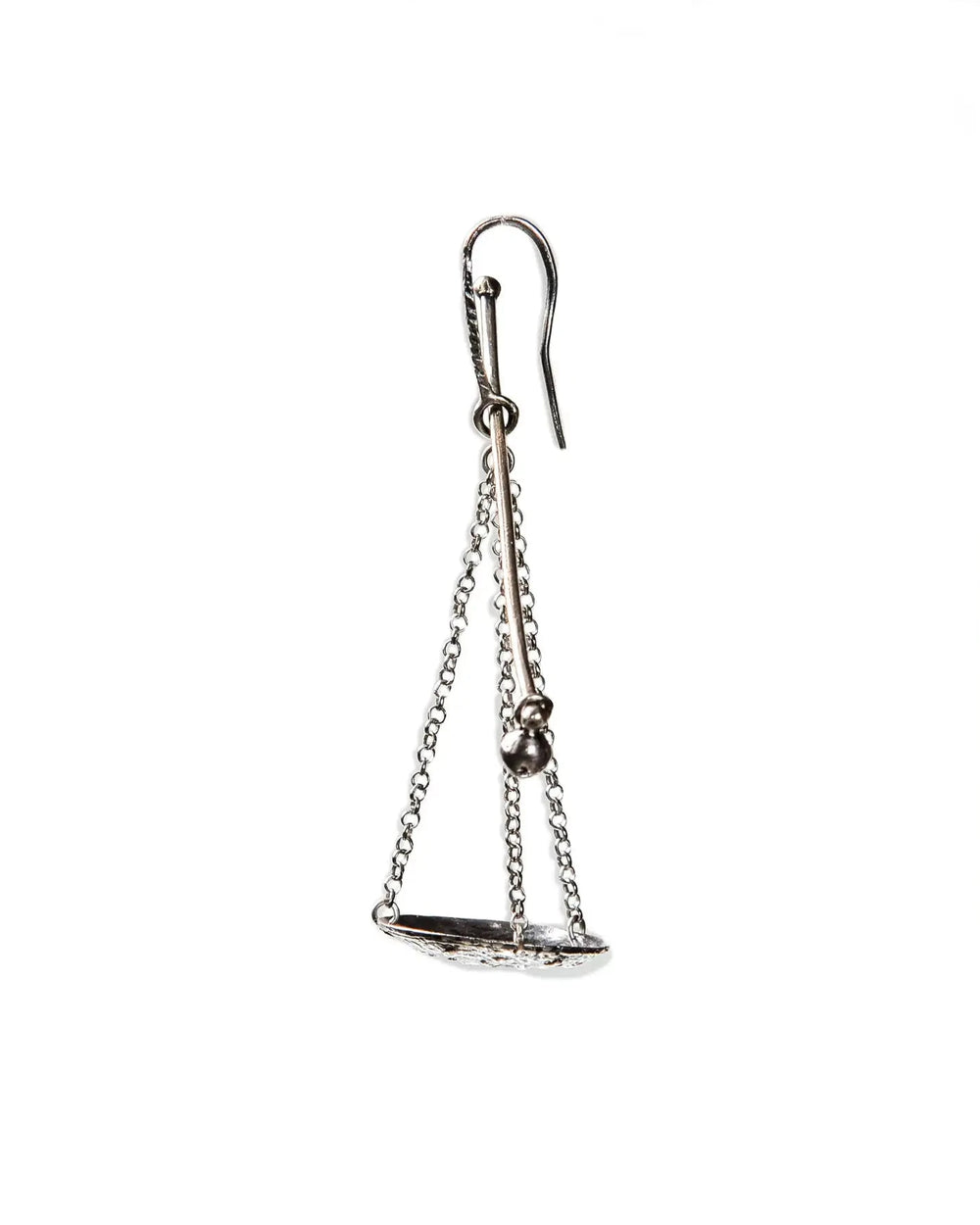 A single silver earring featuring a scale or balance weight. Featuring fine chains and a silver plate.