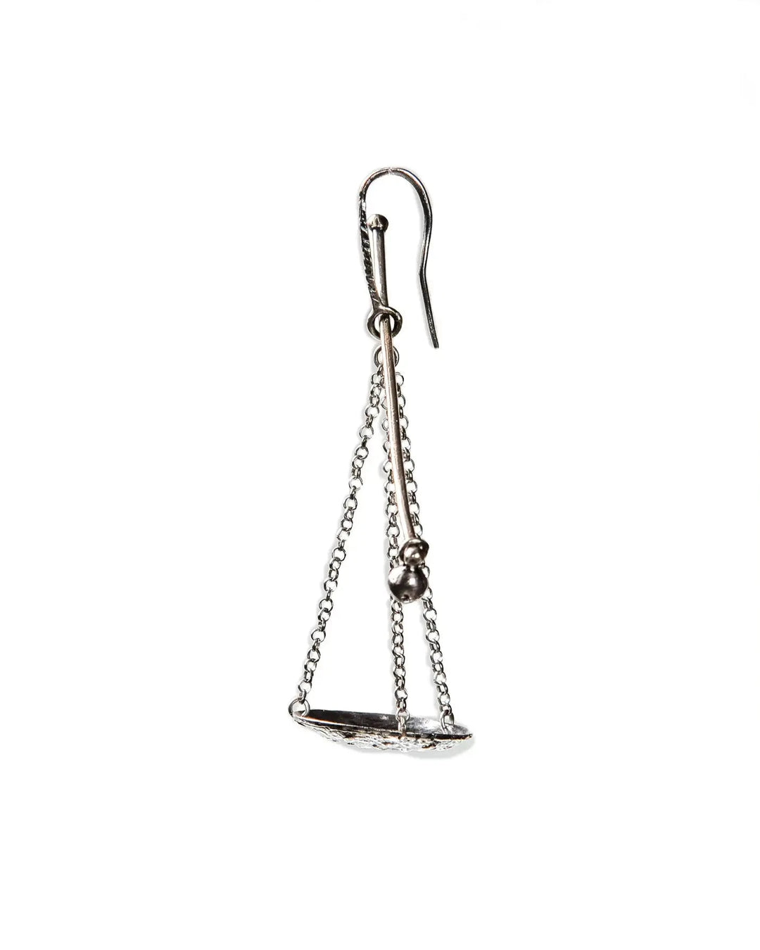 A single silver earring featuring a scale or balance weight. Featuring fine chains and a silver plate.