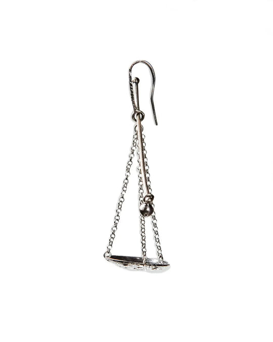 A single silver earring featuring a scale or balance weight. Featuring fine chains and a silver plate.