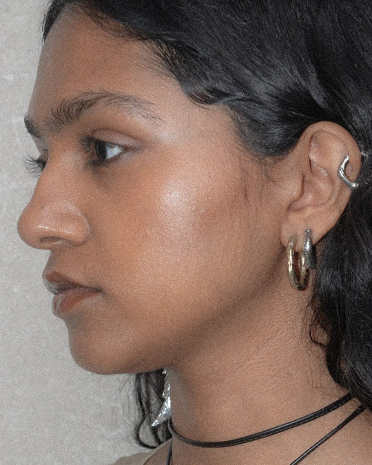 A combination of silver and bronze hoop earrings that creates a classic yet unique look