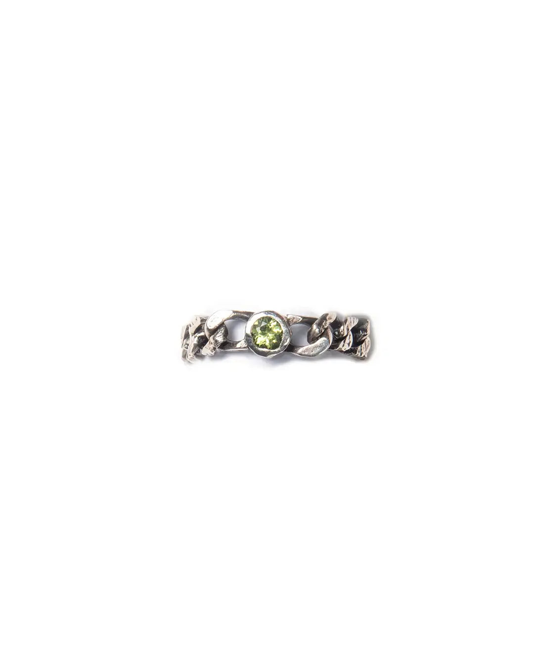 A silver ring with a chain design with a central green peridot gemstone