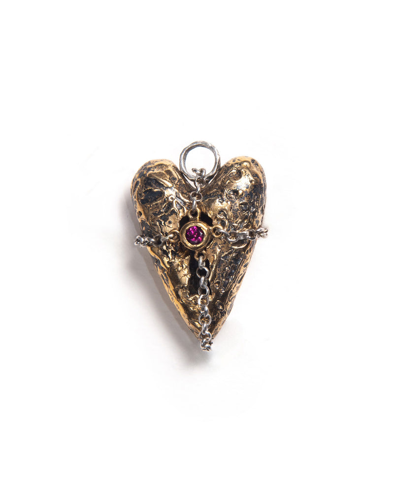 3D bronze heart-shaped amulet with textured finish, featuring a locket-style opening, wrapped in a silver chain forming a cross pattern with a central gemstone. It featured a gothic inspired design with intricate details and mixed metal.