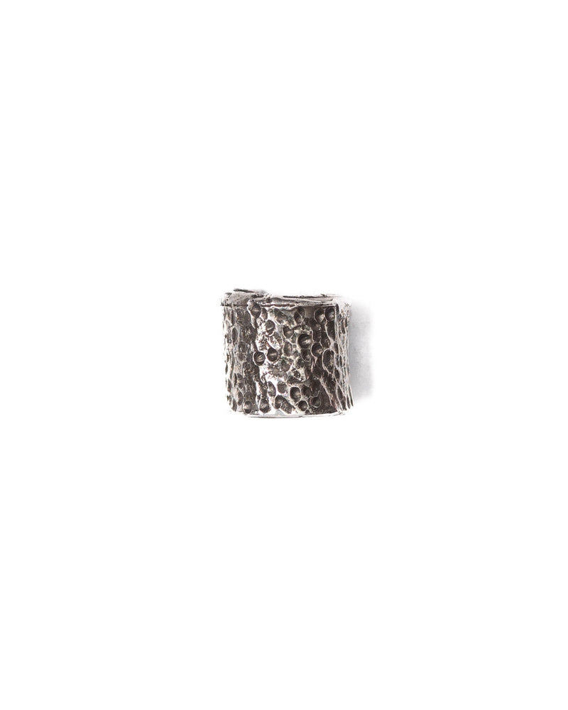 A single silver ear cuff with a textured design