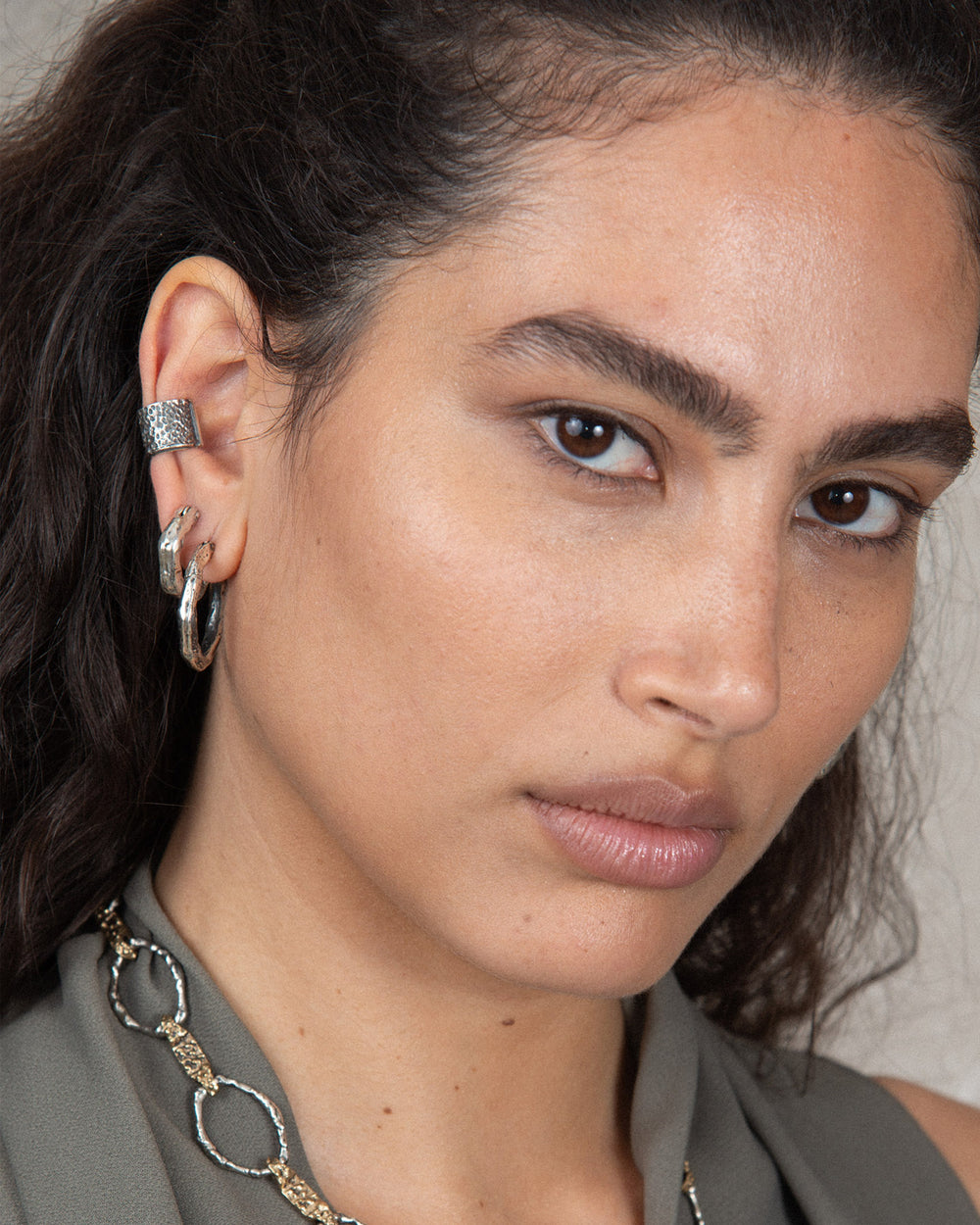 A woman wearing minimalistic and timeless handmade silver earrings 