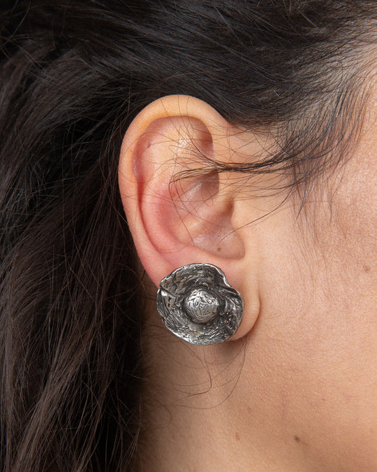 Close-up of the flower component with an earthy, textured finish, showcasing intricate surface details and organic design, worn alone as a delicate and natural accent.