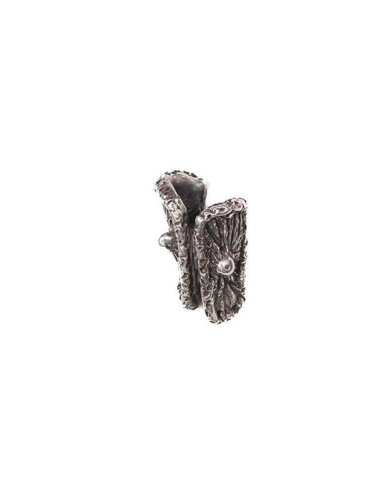 A silver single ear cuff designed to resemble a mushroom with a textured finish.