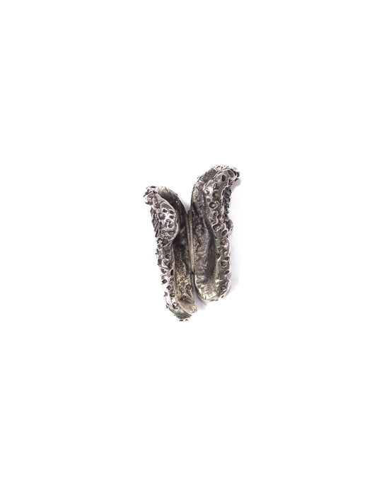 A silver single ear cuff designed to resemble a mushroom hat with a textured finish, viewed from the back side to showcase the detailed craftsmanship and how it wraps around the ear.