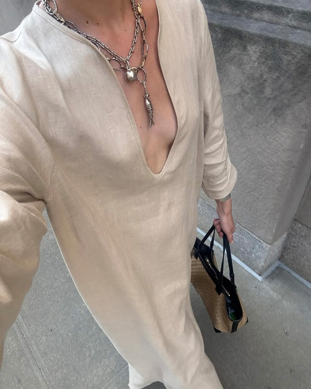 Muse Christie Tyler styling the fish neck piece with a deep neckline dress and a Tiffany necklace