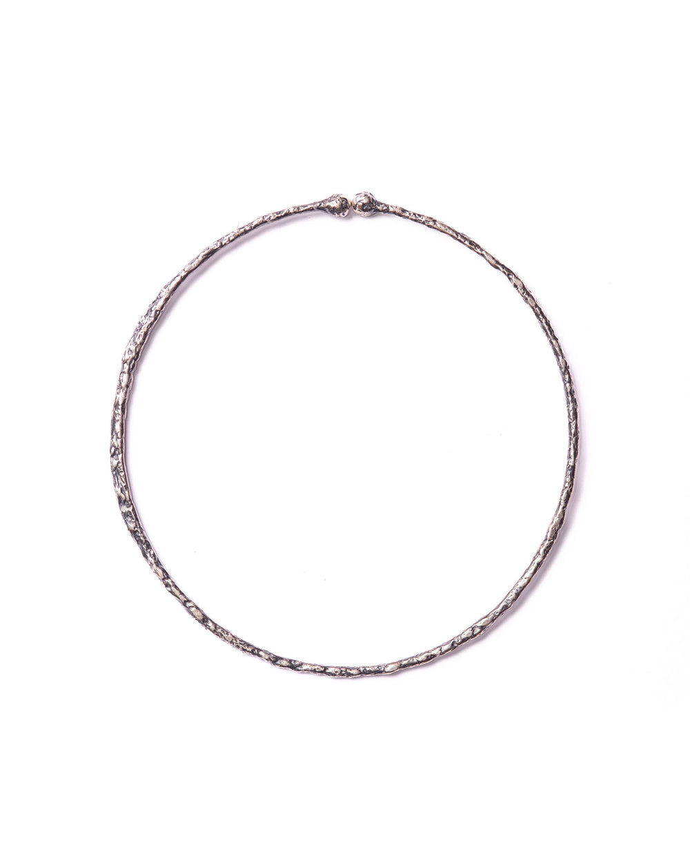 Close-up of the large silver ear cuff, showcasing their handcrafted organic textures and sleek, sophisticated design