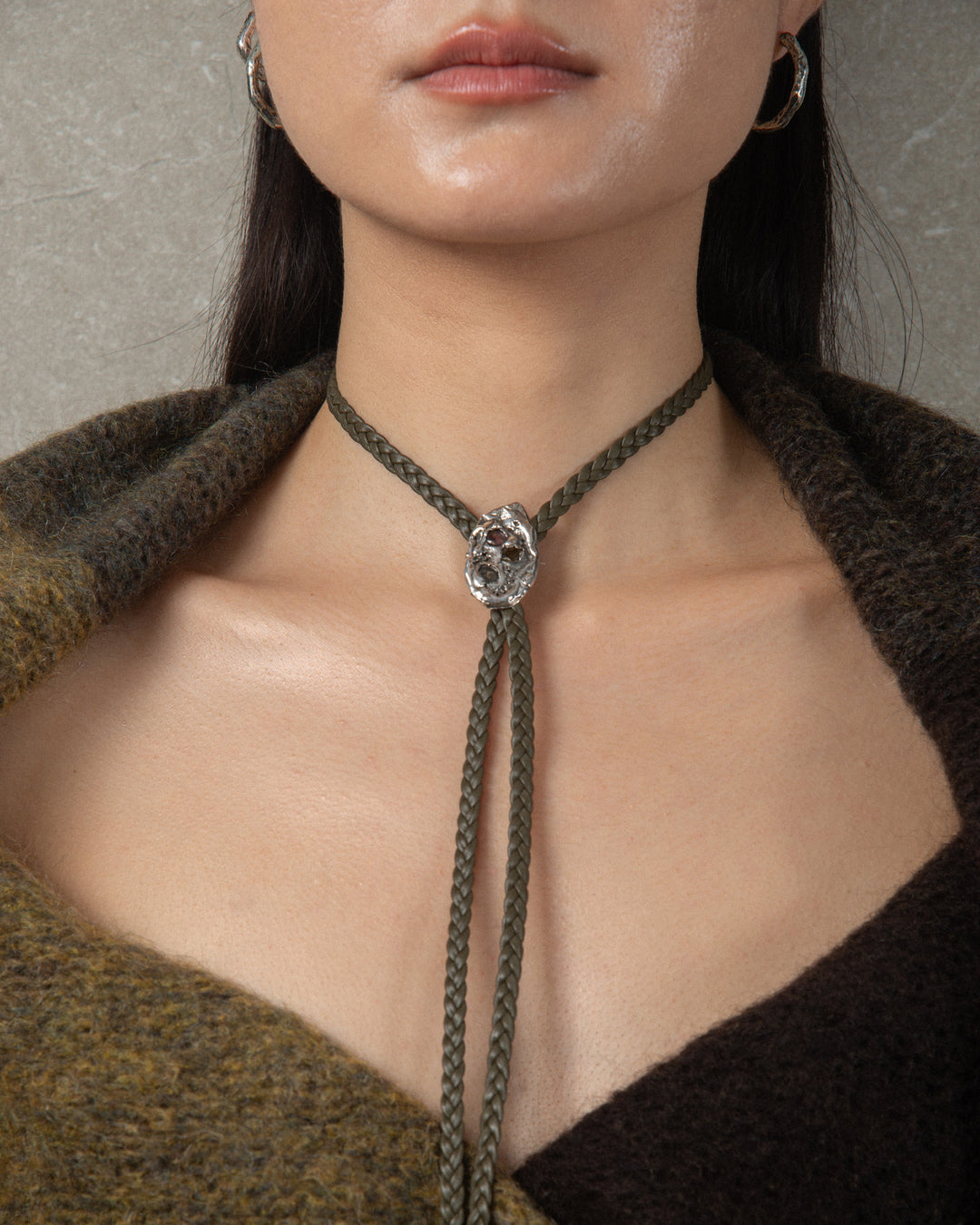Handcrafted silver ornament with textured finish and vibrant watermelon tourmalines, styled on a bolo tie for a truly original accessory