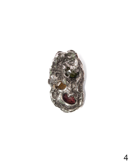 Unique silver pendant featuring textured craftsmanship and multicolored natural gemstones