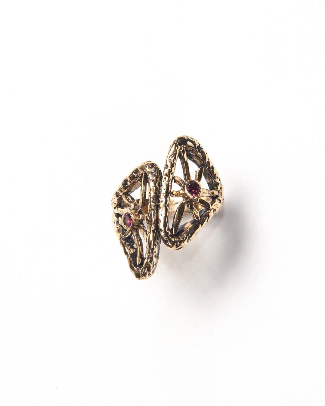 A bronze ring with a textured finish and natural stones framed by metal rays