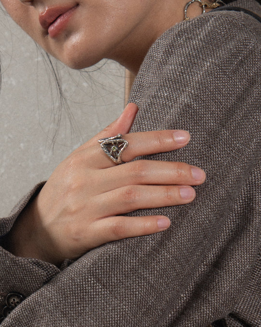 Woman wearing a statement ring with molten finish