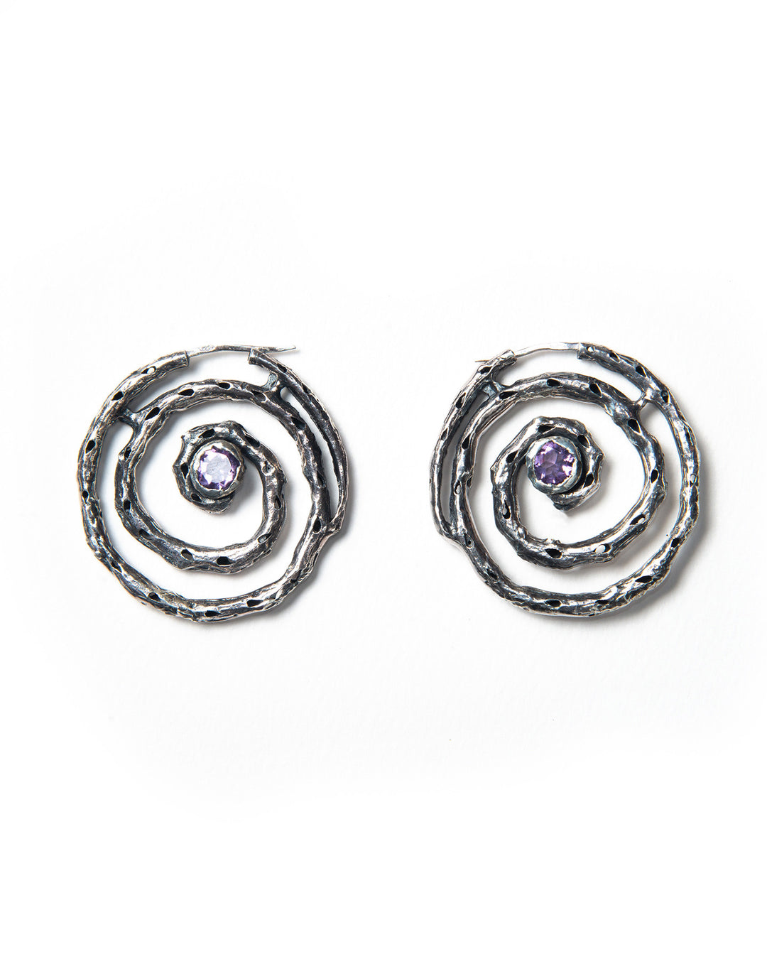 A pair of silver hoop earrings with a textured finish and purple amethyst stones, crafted in Italy.