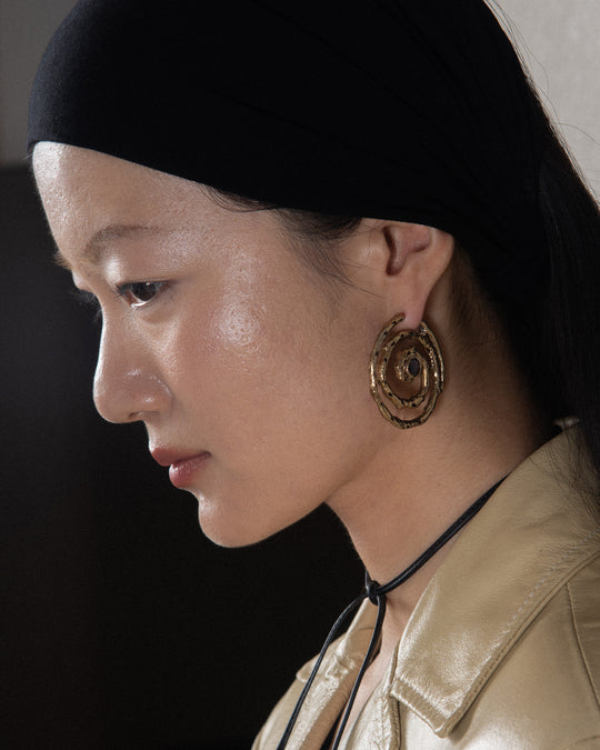 gold hoop handmade earring on elegant woman